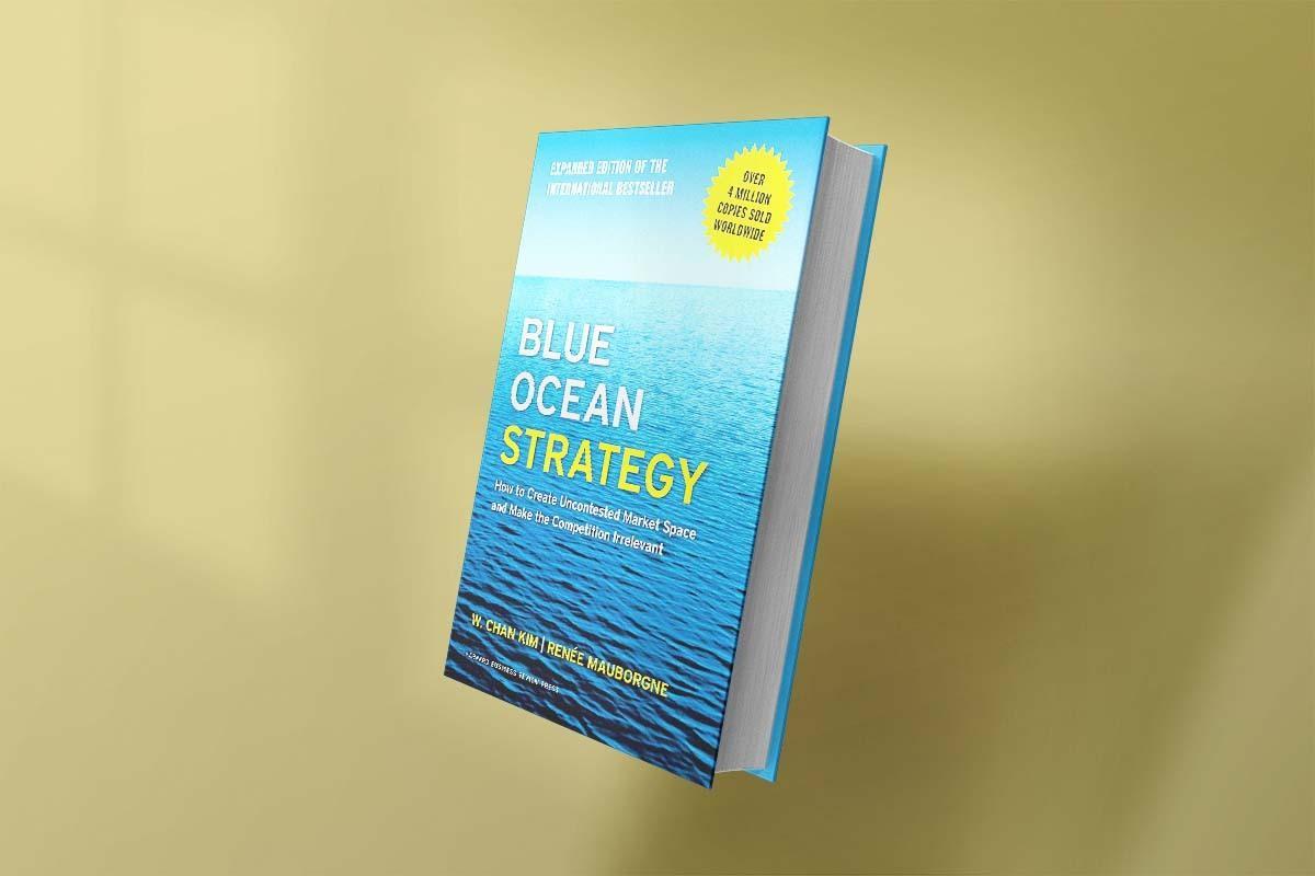 The book Blue Ocean Strategy by W. Chan Kim and Renée Mauborgne with a blue ocean cover, emphasizing market innovation with the subtitle "How to Create Uncontested Market Space and Make the Competition Irrelevant.