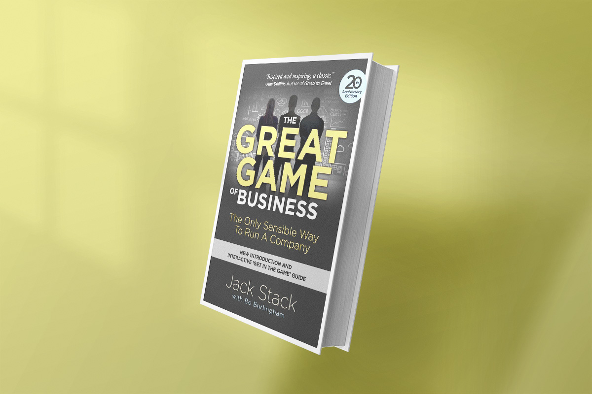 Cover of The Great Game of Business by Jack Stack, featuring bold yellow and white title text on a dark chalkboard-style background with silhouettes of businesspeople.